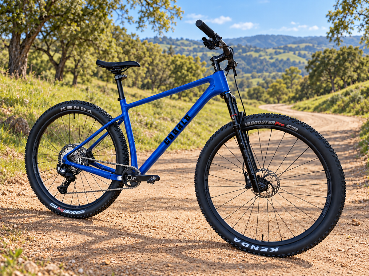 Gloss blue Cobalt Diablo hardtail mountain bike on a sunlit dirt trail