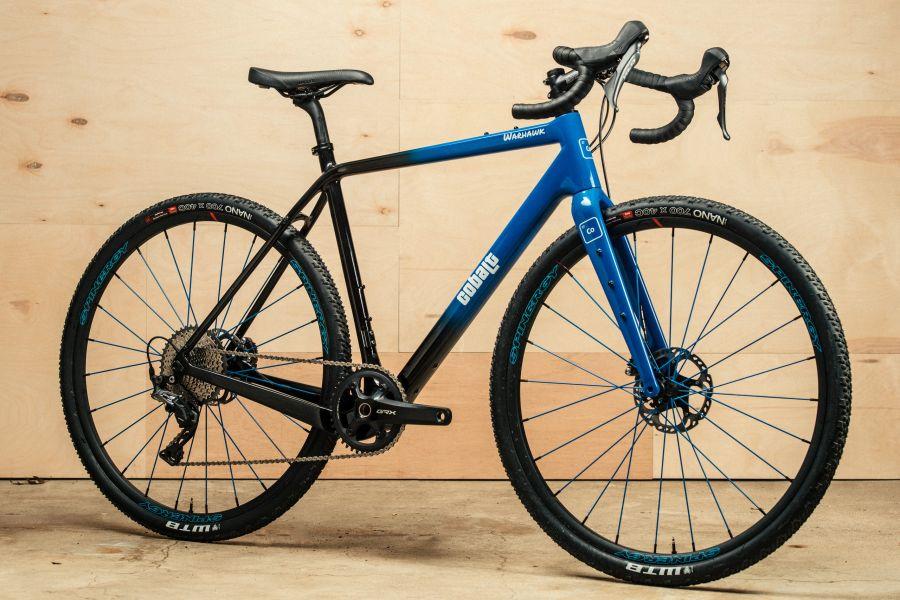 Black and blue Cobalt road bike against a wooden backdrop