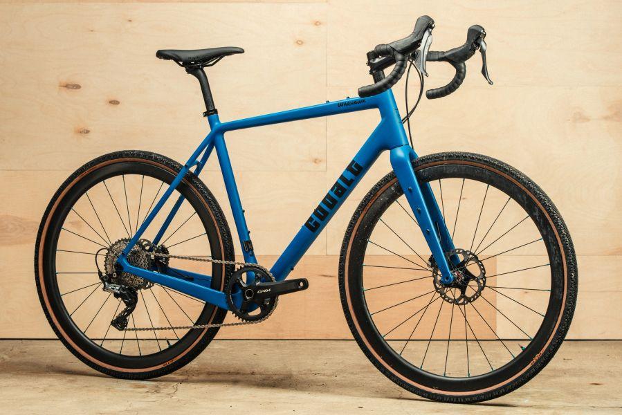 Blue Cobalt road bike against a wooden backdrop