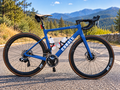Cobalt Spitfire road bike in Pantone 3506C blue with white decals on a mountain road
